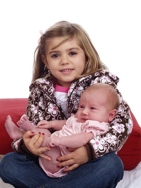 Cute Young Girl Holding Infant Baby Sitting Stock Photo - Image of ...