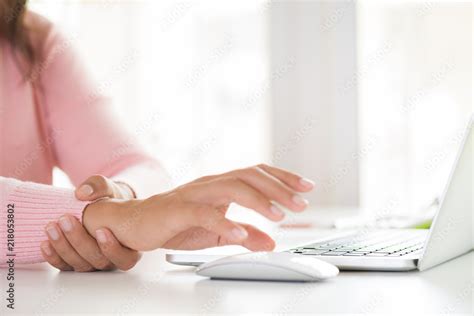 Closeup woman holding her wrist pain from using computer. Office ...