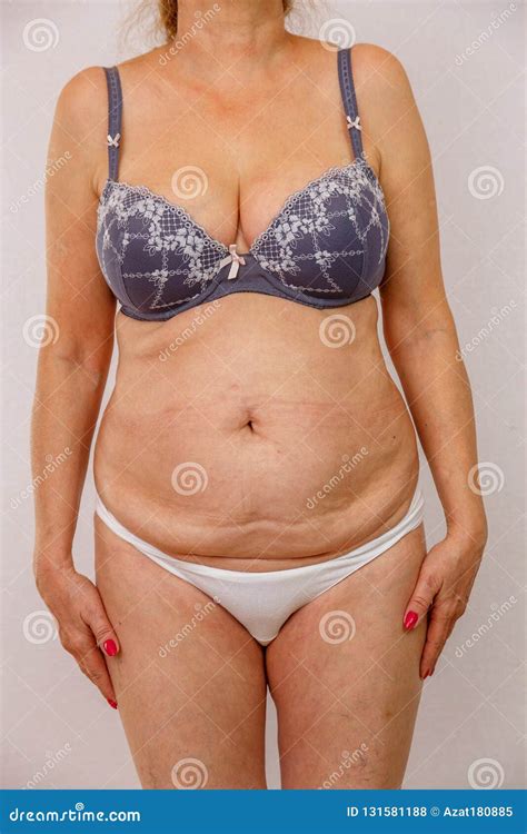 Photo of an Elderly Woman in Underwear on a White Isolated Background ...