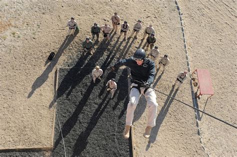 Instructor demonstrates proper rappelling techniques during training ...