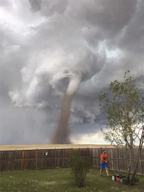 Viral photo shows Canadian mowing lawn unfazed by tornado in background | cleveland.com