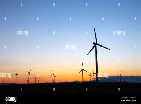 wind turbines field at sunset Stock Photo - Alamy