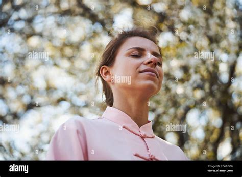 Female closing her eyes outside during meditation Stock Photo - Alamy