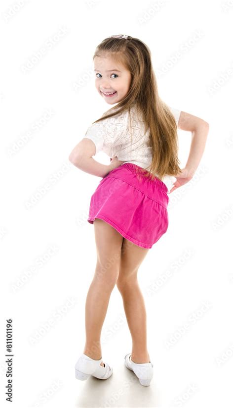 Adorable happy little girl posing back view isolated Stock Photo | Adobe Stock