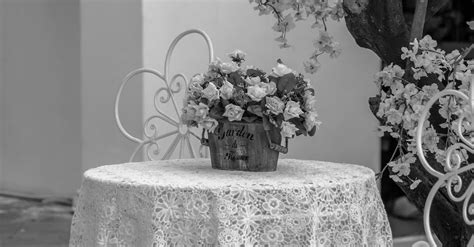 Monochrome Photo of Table with Floral Table Cloth and a vase · Free Stock Photo