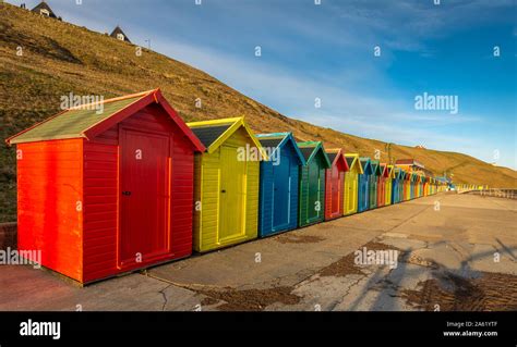 Colourful beach huts at Whitby beach Stock Photo - Alamy