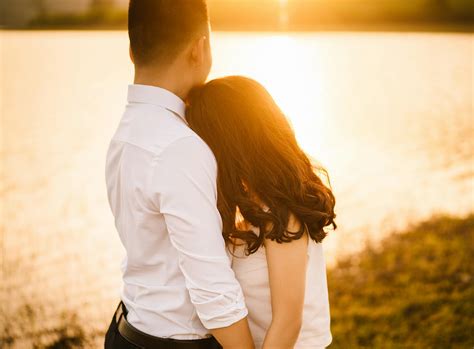 Woman Hugging Man in Front of Body of Water · Free Stock Photo