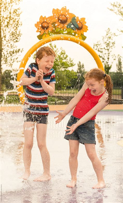 "Children Playing In A Water Play Area" by Stocksy Contributor "Craig Holmes" - Stocksy