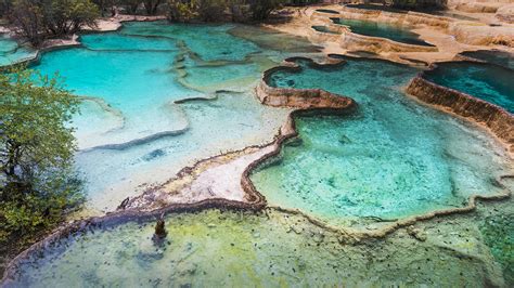 Colourful pools formed by calcite deposits, Huanglong, Sichuan province ...