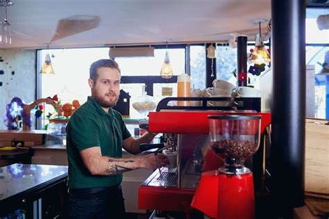 Premium Photo | Barista makes a hot drink on coffee machine at the bar