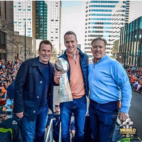 three men standing next to each other holding a trophy in front of a ...