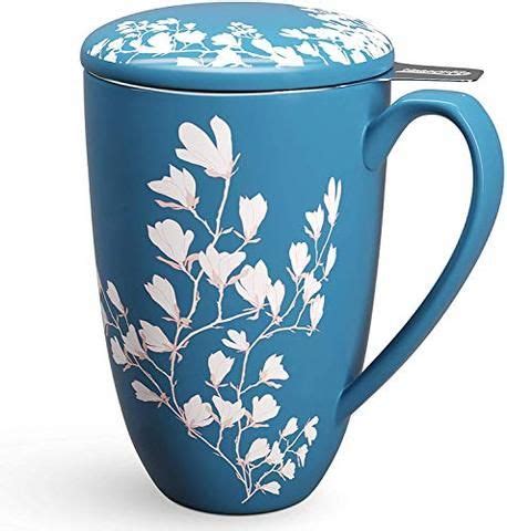a blue mug with white flowers on it