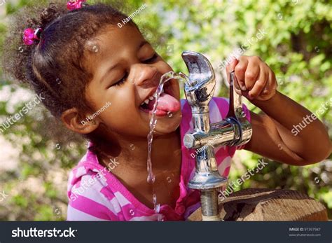 Kid Drinking Water From Fountain