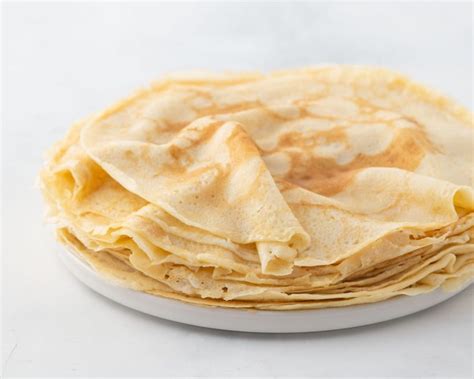 Crepes, thin pancakes with honey on a white plate. Marble background. Close up. - Simple Simon ...