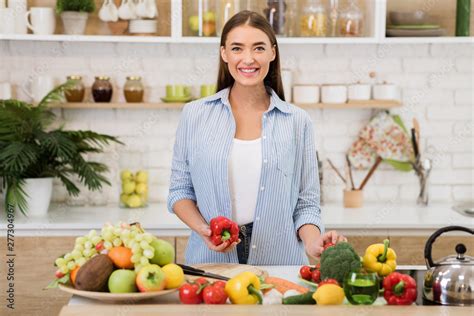 Healthy lifestyle. Young woman cooking in the kitchen Stock Photo ...