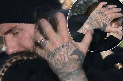 David Beckham shows off mystery tattoo on his wedding ring finger after surprising Victoria in ...