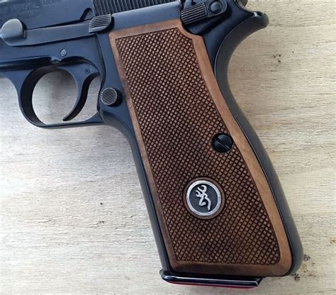 Browning Hi Power grips made from Walnut wood and Browning Logo made of Silver.