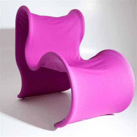 a pink chair sitting on top of a white floor