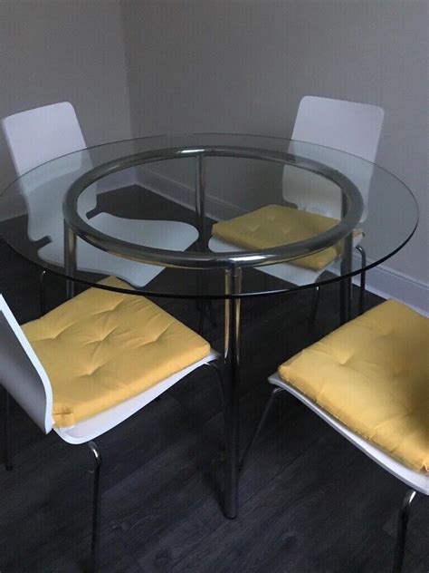 Ikea round glass table with four white chairs | in Newcastle, Tyne and Wear | Gumtree