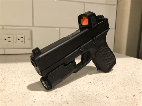 Glock 19 with a Holosun 507c. Slide cut by Battlewerx. : r/Glock19