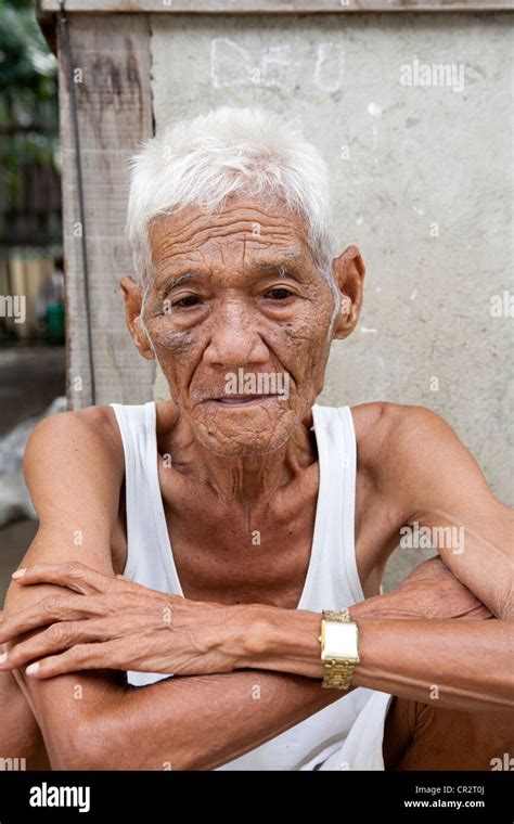 An old Filipino man sitting outside his home. Lapu-Lapu City, Metro ...