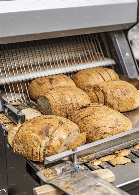 Sourdough bread slicing in industrial bread slicing machine | Stock ...