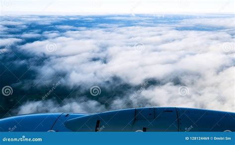 Airplane above clouds stock image. Image of light, landscape - 128124469