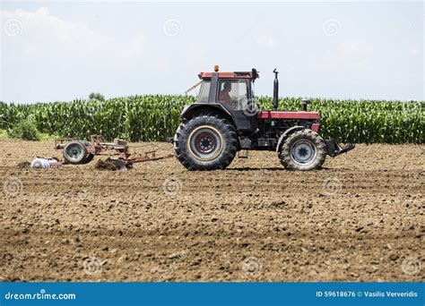 A Tractor Working Planting Wheat in the Fertile Farm Fields of G ...