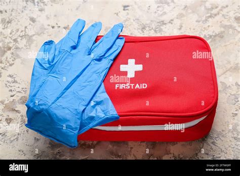 First aid kit and medical gloves on grunge background Stock Photo - Alamy