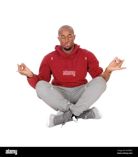 African man sitting on floor in a yoga pose Stock Photo - Alamy