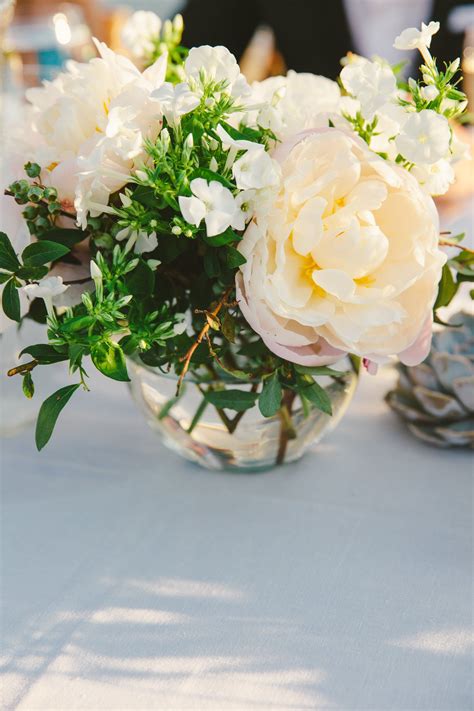 Arrangements of peonies and stephanotises in a variety of glass vases created a ro… | Flower ...