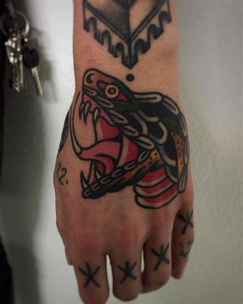 Snake tattoo on the left hand - Tattoogrid.net