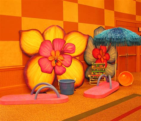 Hawaiian themed backdrop | #flowers #umbrella #flipflops #EventuresInc ...