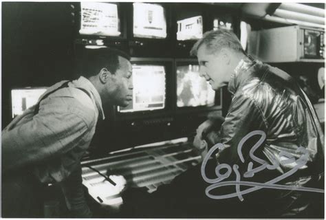 two men standing in front of televisions and looking at each other's ...