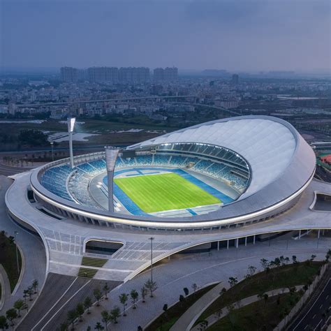 Aluminium louvres and a membrane roof shade Wuyuanhe Stadium by GMP Architekten A crescent ...