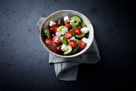 Salad with Kalamata Olives, Cucumber Cherry Tomatoes and Feta Cheese on Black Stone Background ...