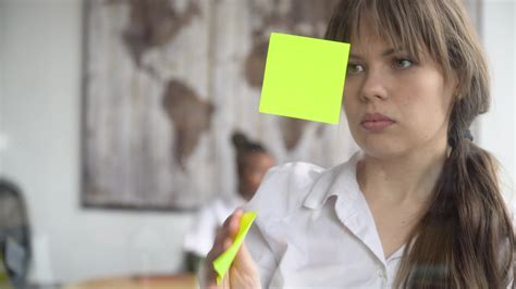 Business woman using sticky notes solving strategy on glass whiteboard ...