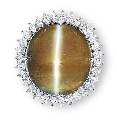 A CAT'S EYE CHRYSOBERYL AND DIAMOND RING | Christie's