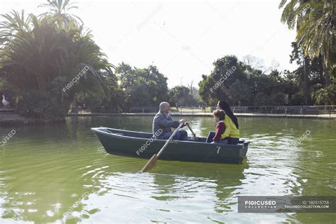 Family in rowing boat on lake together — woman, adventure - Stock Photo | #180515728