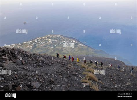 Tourist group hiking to the crater of Mt Stromboli, volcanic island of Stromboli, Aeolian ...