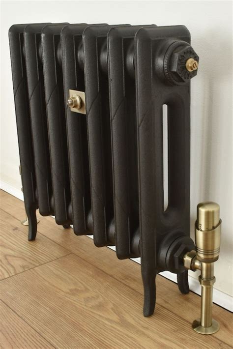 Black cast iron radiator with antique brass valves and fittings ...