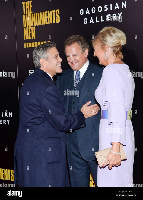 Director and actor George Clooney, left, greets actor Hugh Bonneville ...