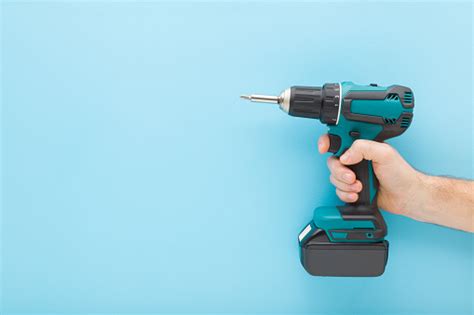 Young Adult Man Hand Holding And Showing Dark Black Green Professional Battery Screwdriver On ...