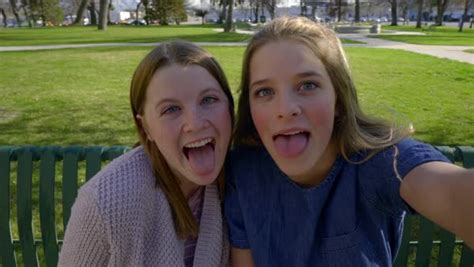 Funny teen girls pose for selfies on a park bench, they make cute and silly faces - Stock Video ...