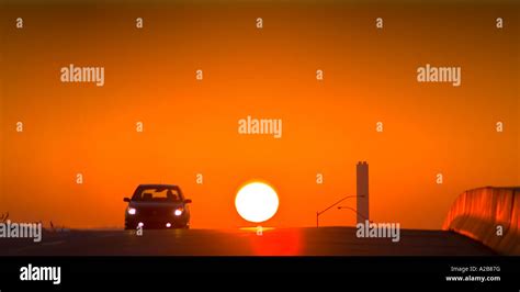 Car Silhouette And Sun At Sunset On Highway, USA Stock Photo - Alamy