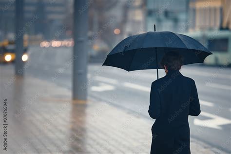 Man Walking Alone In Rain