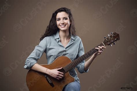 Beautiful girl playing guitar - stock photo | Crushpixel