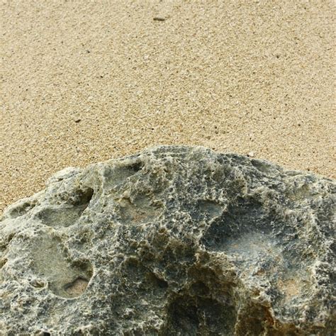 Premium Photo | Rocks and sand on the beach