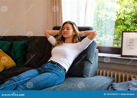 Young Woman Relaxing on Sofa Recliner with Eyes Closed and Hands Behind Head Stock Image - Image ...