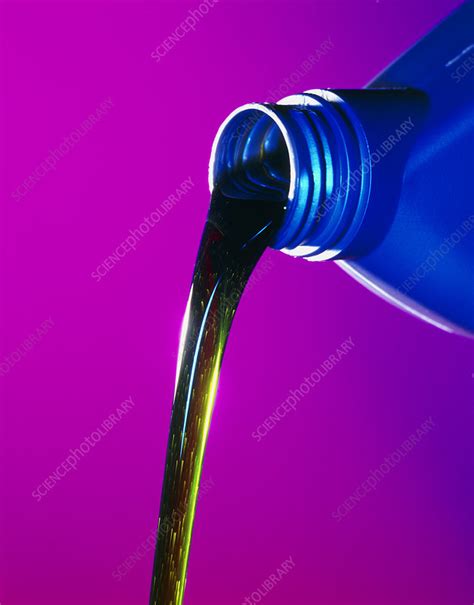 View of lubricating oil pouring from its bottle - Stock Image - T110/0371 - Science Photo Library